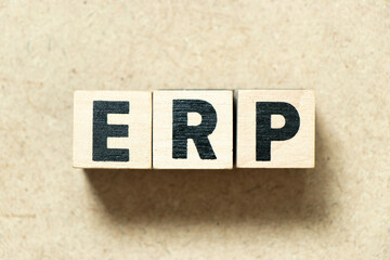 Alphabet letter block in word ERP (abbreviation of  Enterprise Resource Planning) on wood background