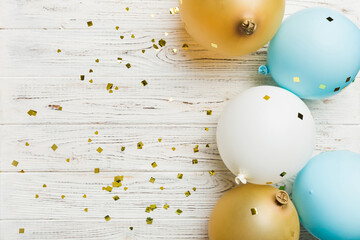 Holiday background with colorful balloon, gift and confetti. Flat lay style. Birthday or party...
