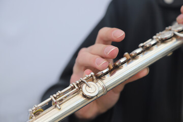 close-up of the hands of a street musician playing the flute