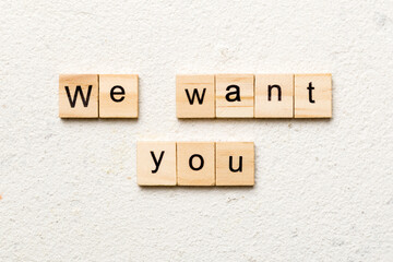 We Want You word written on wood block. We Want You text on cement table for your desing, concept