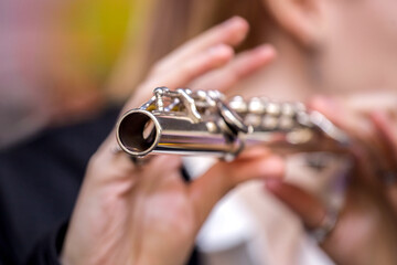 close-up of the hands of a street musician playing the flute
