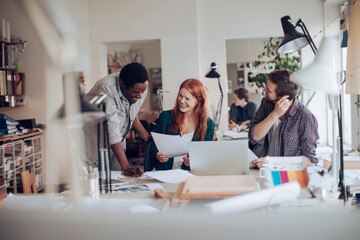 Young and diverse group of colleagues working on a project together in a modern business office