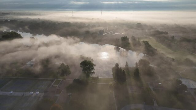 A foggy morning aerial view of Frank N. Andersen Celebration Park in Saginaw, Michigan.  	