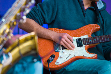 a musician plays an electric guitar on a stage