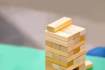 close-up of a child's hand playing wood blocks stack game