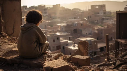 Deurstickers Marokko Morocco Shaken: Lonely child looking down to ruined city after earthquake