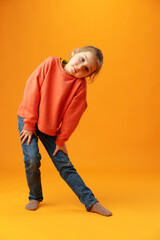 Fototapeta premium Portrait of upset little girl against yellow background
