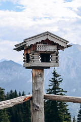 Beautiful wooden birdhouse set in the Bavarian Alps
