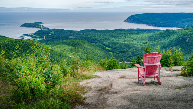 Red adirondack chair at the top of Franey hiking trail, Cap Breton Highlands national park, Nova Scotia, Canada