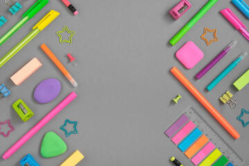 Stationery background of colorful rainbow school and office stationery set on gray background. Flatly, copyspace.