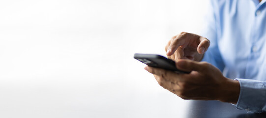 Male hand typing and searching on smartphone.