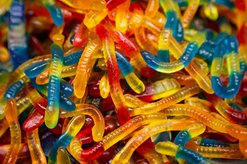 Candy background, chewing jelly candies in the form of worms, close-up.