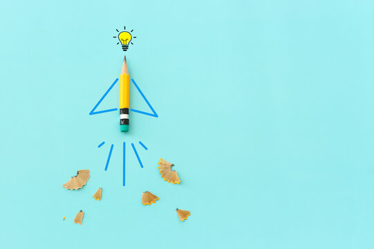Concept image of pencil as rocket metaphor on blue background