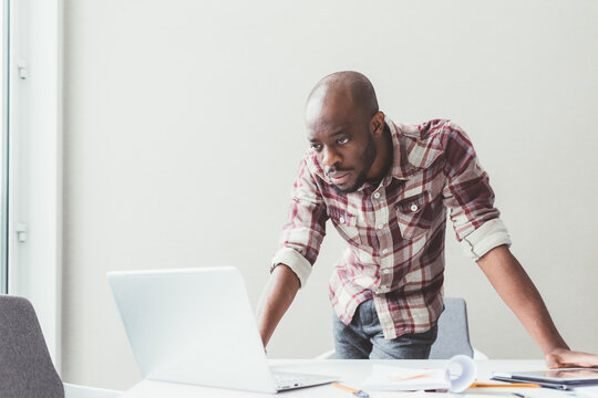 young black businessman using computer working indoors office