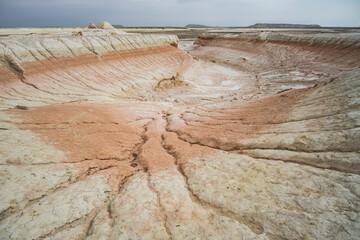 Hills of chalk and limestone and slopes of multi-colored mountains with weathering and washouts from water, colored relief in the steppe