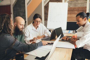 Group of young people designers having meeting in a modern office.