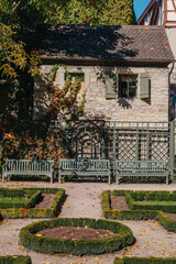 House with nice garden in autumn season. Flowers in the City Park of Bietigheim-Bissingen, Baden-Wuerttemberg, Germany, Europe. Autumn Park and house, nobody, bush and grenery