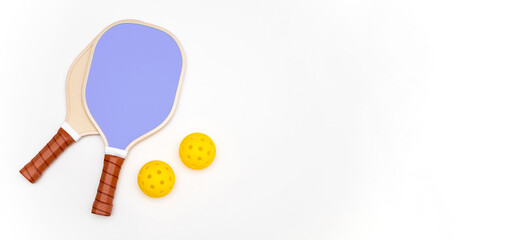 Photo composition of 2 pickleball rackets and two balls on a white studio background with copy space on the right.Pickleball concept. Pickleball advertising.