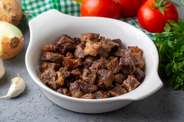 Muslims Traditional Sacrifice holiday food lamb, Turkish roasted meat in copper pot on table top. Turkish Kavurma. (Turkish name; Kurban kavurma)