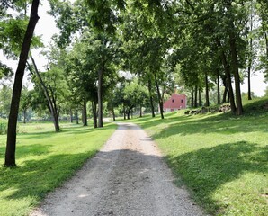 The empty gravel road in the countryside on a sunny day.