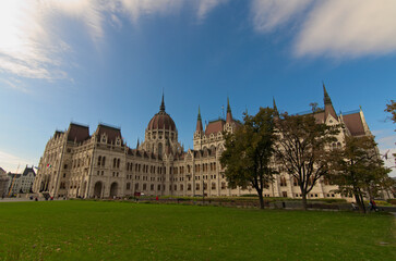 Wide-angle view of Hungarian Parliament Building against blue sky. One of the most beautiful buildings in Budapest. Travel and tourism concept