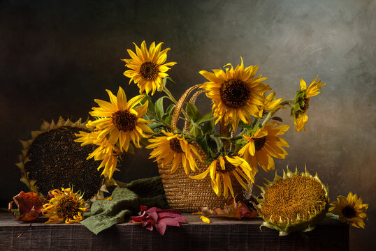 Still life with a bouquet of sunflowers on an old wooden table