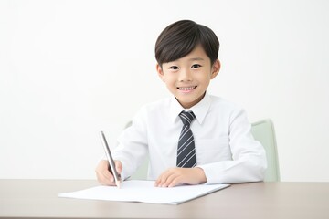 Happy Japanese School Boy Doing Homework