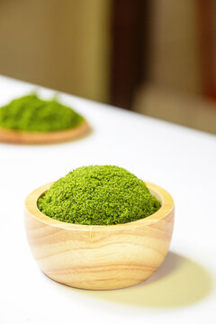 Wolffia globosa in wooden bowl. Wolffia is the nutrient-rich plant-based source of protein and omega3 and vital minerals like zinc, calcium, iron, B12 and so much more.