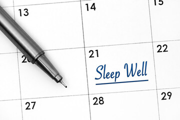 Calendar date with reminder Sleep Well and pen near.