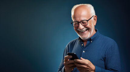 An elderly man smiling and laughing with his phone against a colored background.