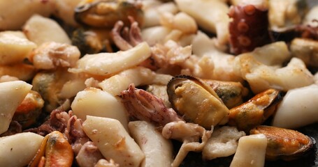 Frying seafood. Sea food cocktail with shrimp, octopus and mussels are placed in a pan. A series of photos to visualize the recipe.