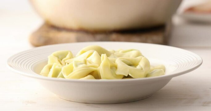A plate of hot tortelloni pasta. Food preparation in the kitchen. A series of footage to visualize the recipe.