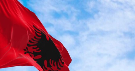 Albanian national flag waving in the wind on a clear day