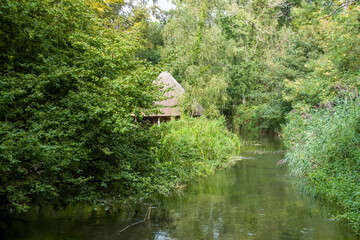 Fototapeta na wymiar Thatched Fishing Hut on the River Test Hampshire England