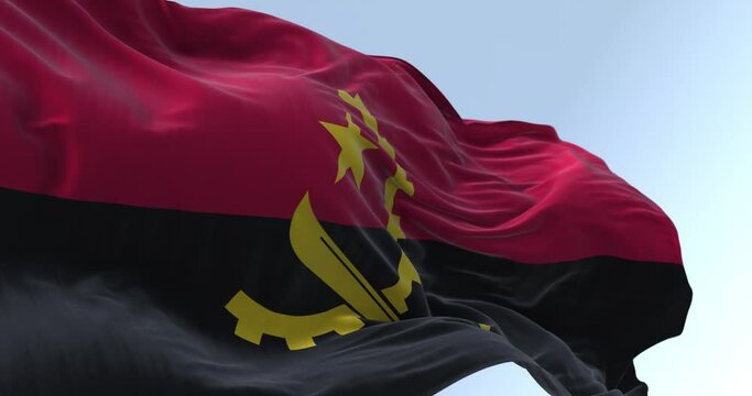The national flag of Angola waving in the wind on a clear day