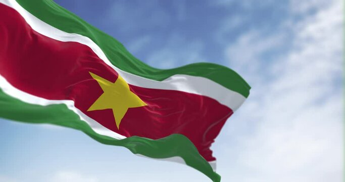 Suriname national flag waving in the wind on a clear day.