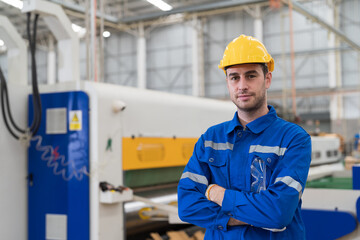 Male electrician engineer maintenance electric system in industry factory. Factory male worker at work in the industry factory, work with CNC machine. Factory engineer male worker maintaining machine