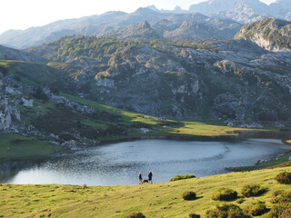 two girls and a dog enjoy the views of the lakes of covadonga