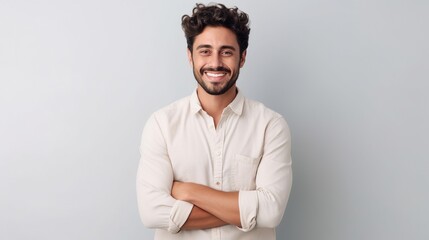 man standing over a white background with a happy face and crossed arms looking at the camera - obrazy, fototapety, plakaty