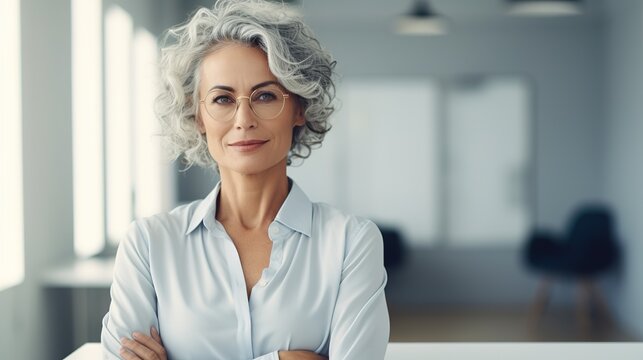 Smile, crossed arms, and image of senior businesswoman at office with confident and cheerful attitude. Happy, ambitious, and professional old female ceo, entrepreneur, or boss in a modern workplace
