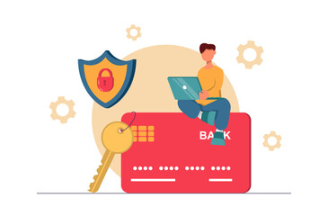 Online banking. A man with a laptop sits on a credit card, keys and a lock nearby