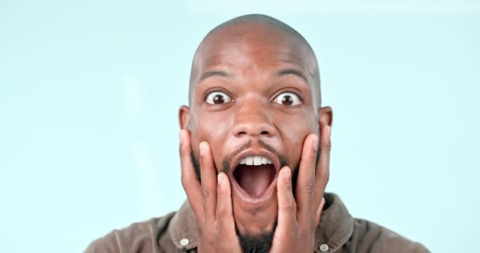 Surprise, wow or face of black man in studio with gossip, story and fake news in studio on blue background. Portrait, mind blown expression or hands on head for announcement, secret or notification