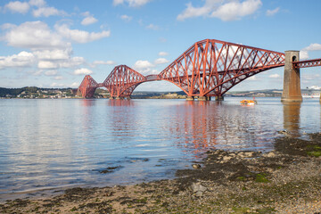 The Forth Bridge is a railway bridge across the Firth of Forth in Scotland. Is considered a symbol of Scotland, and is a UNESCO World Heritage Site. Designed by  Sir John Fowler and Sir Benjamin Baker