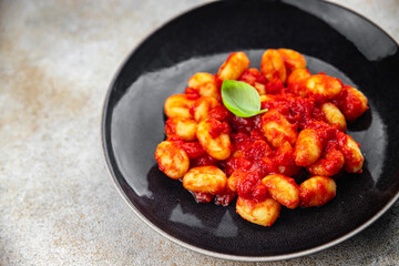 gnocchi tomato sauce no meat potato dish meal food snack on the table copy space food background rustic top view vegetarian vegan food  