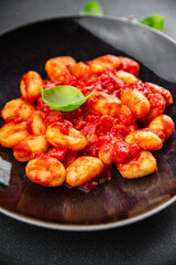 gnocchi tomato sauce no meat potato dish meal food snack on the table copy space food background rustic top view vegetarian vegan food  
