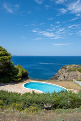 Image of a private pool with privileged views of the Mediterranean Sea, as a boat crosses it in the...