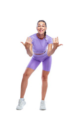 A slender young smiling woman in purple sportswear calls with her hands to herself. Sports, activity, energy and health. Isolated on white background. Full height. Vertical.