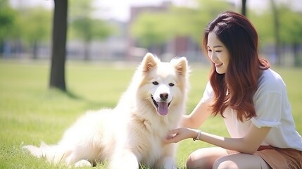 Asian woman pet a dog at outdoor park - obrazy, fototapety, plakaty