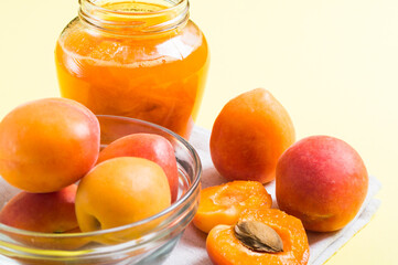 Jam from apricots in a glass jar with ripe apricot