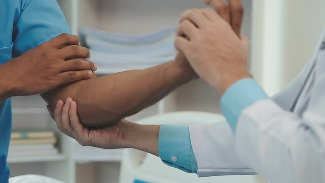 Therapist treating a male injured by rotator cuff stretching method, Physical therapy concept.